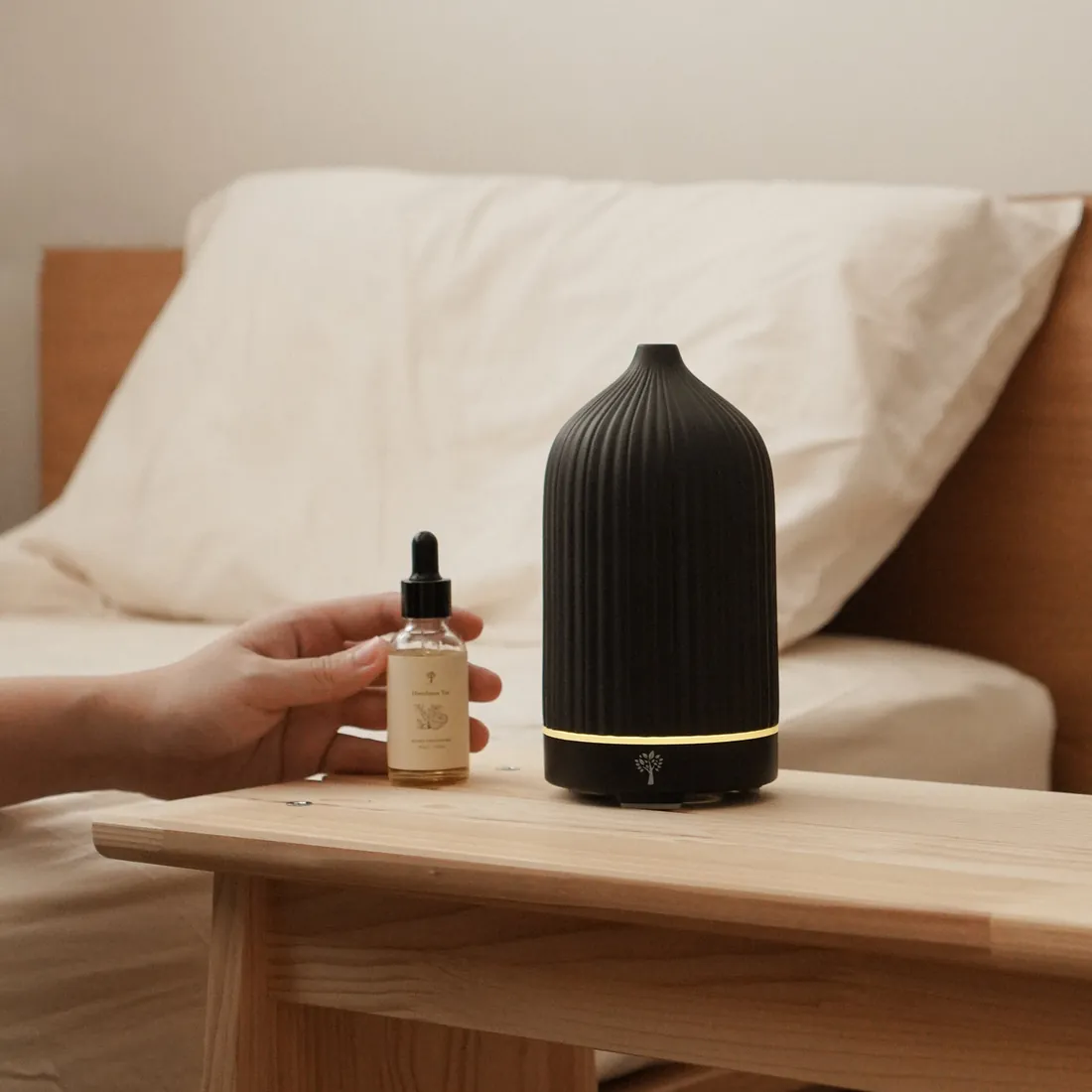 A black Pristine mist diffuser on a bedside table